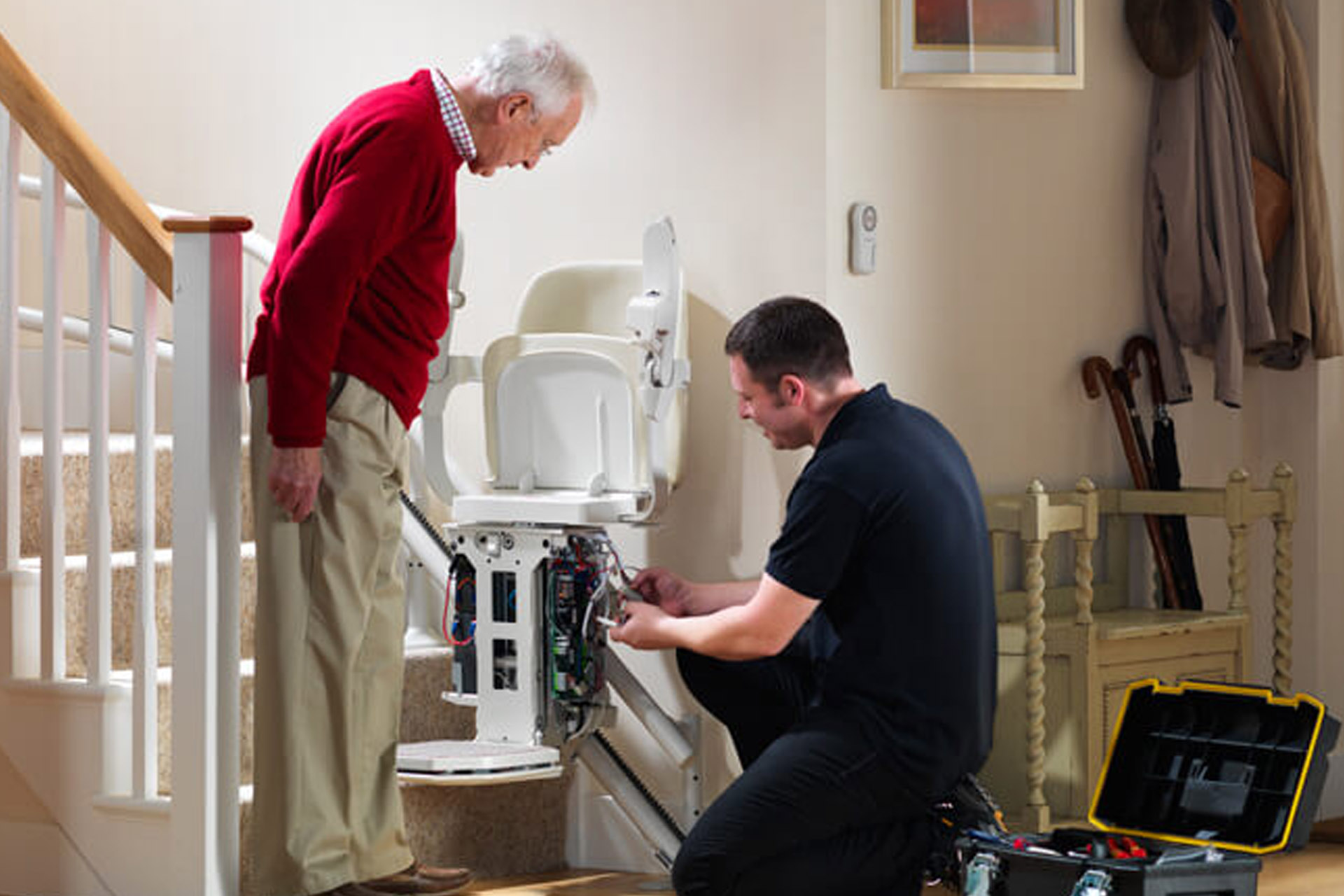 Chairlift repair Dublin Ireland — engineer repairing a stairlift at a customer's home